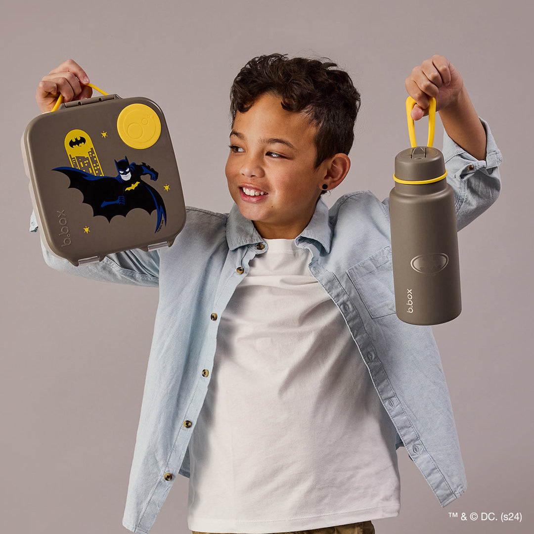 Child holding B.Box Batman lunch box and matching drink bottle, sold separately