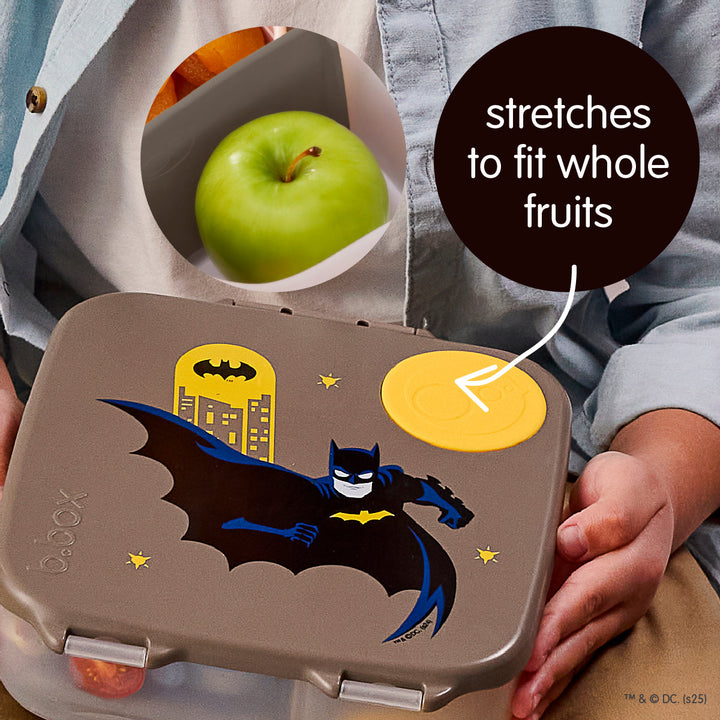B.Box Batman lunch box with flexible silicone fruit section holding a whole apple