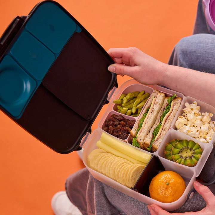 Night Vision lunch box open with packed sandwich and fruit