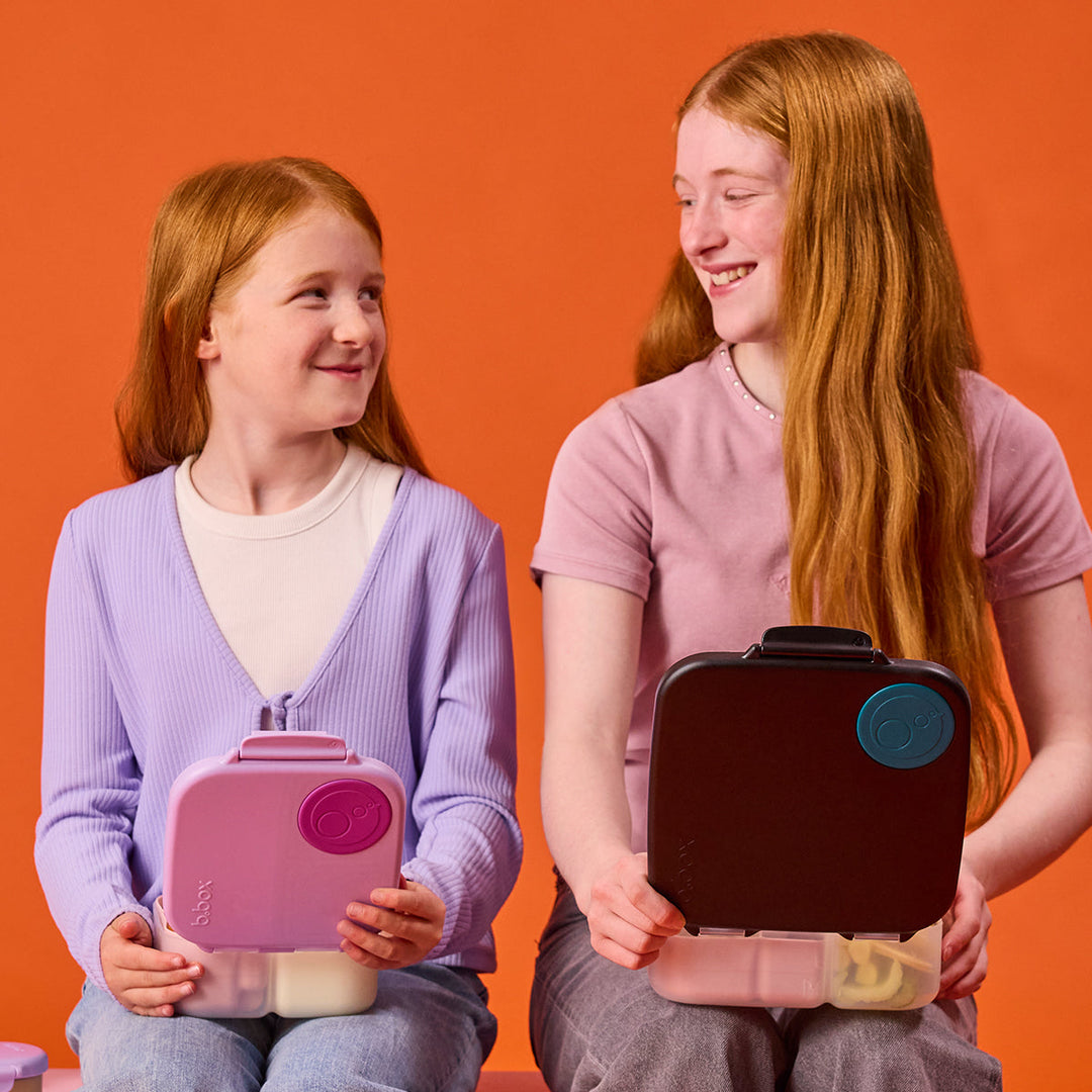 Adult and child holding lunch boxes including Night Vision