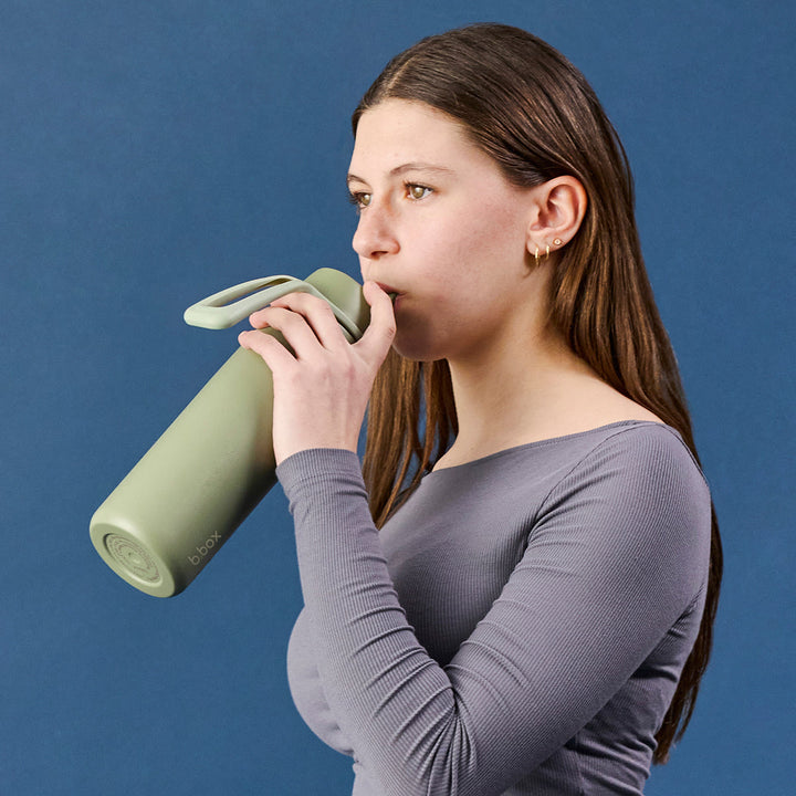 Woman drinking from Olive 690ml insulated bottle