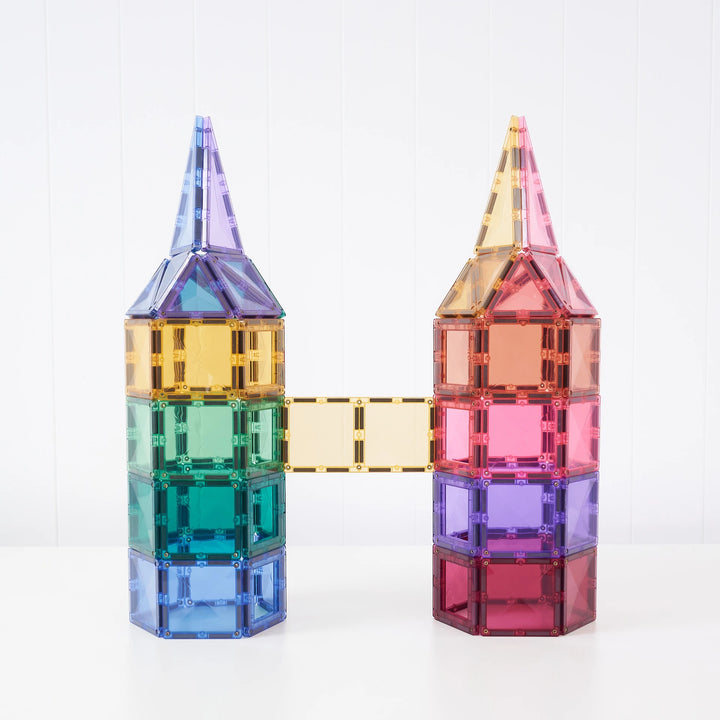 Connetix pastel magnetic tiles built into two pointed towers joined by a bridge