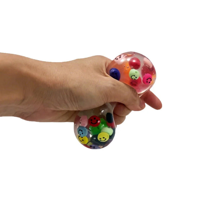 Epic Squish Smiley Ball being gently squeezed by hand