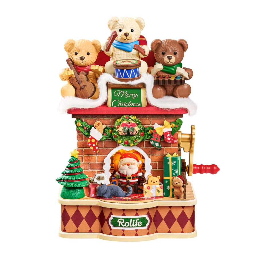 Rolife Christmas fireplace music box on white background, three teddy bears playing instruments above a Merry Christmas sign, brick fireplace with Santa, tree, gifts and red crank handle.