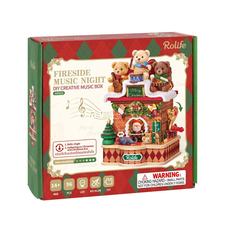 Rolife Fireside Music Night DIY creative music box packaging box, red and green diamond pattern, showing three teddy bears playing instruments above a brick fireplace with Santa, Christmas tree and gifts; 96 pieces, LED, no glue, age 14+.
