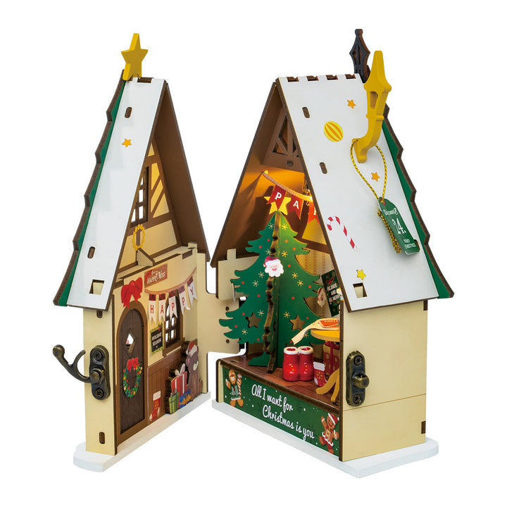 Rolife Twinkling Christmas House DS036 open book view showing illuminated Christmas tree interior and holiday room scene